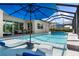 Relaxing pool with swim-up seating and blue umbrella at 14516 Ponce De Leon Trl, Port Charlotte, FL 33981