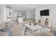 Open living room features a neutral color palette, plush seating, and a large flat-screen TV at 18260 Vizcaya Ct, Venice, FL 34293