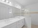 Bright bathroom boasts double vanity, shower, and updated fixtures at 18260 Vizcaya Ct, Venice, FL 34293