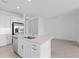 Modern kitchen featuring white cabinets, stainless steel appliances, and an island at 18260 Vizcaya Ct, Venice, FL 34293