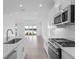 Kitchen with stainless steel appliances, island, and view to backyard at 18260 Vizcaya Ct, Venice, FL 34293