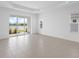 Spacious bonus room with large sliding glass doors and a view of a tranquil lake at 18260 Vizcaya Ct, Venice, FL 34293
