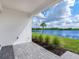 Back patio with pavers overlooking a lake at 18260 Vizcaya Ct, Venice, FL 34293