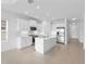 Modern kitchen with white cabinets, stainless steel appliances, and an island at 18260 Vizcaya Ct, Venice, FL 34293