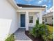 Front entry with a blue door and a paved walkway leading to the house at 18260 Vizcaya Ct, Venice, FL 34293