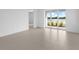 Bright bonus room with sliding glass doors opening to a lake view at 18260 Vizcaya Ct, Venice, FL 34293