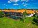 Aerial view of house with pool and screened enclosure at 1929 Tradewinds Cir, Venice, FL 34293