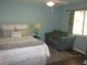 Bright bedroom with a queen bed, armchair, and large window at 3676 Diamond Ave, North Port, FL 34288