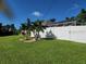 Landscaped backyard with lush lawn and privacy fence at 3676 Diamond Ave, North Port, FL 34288