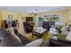 Spacious living room featuring dark leather furniture, a large TV, and a view of the pool at 424 Baycrest Dr, Venice, FL 34285