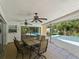 Relaxing poolside patio with table and chairs, ceiling fans at 424 Baycrest Dr, Venice, FL 34285