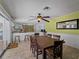 Bright dining area with a large table and access to the patio at 424 Baycrest Dr, Venice, FL 34285