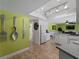 Modern kitchen boasting track lighting, white cabinets, and unique wall art at 424 Baycrest Dr, Venice, FL 34285