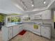 Bright kitchen with white cabinets, track lighting, and pool view at 424 Baycrest Dr, Venice, FL 34285