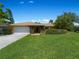 Ranch style home with attached garage and manicured lawn at 424 Baycrest Dr, Venice, FL 34285