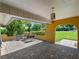 Covered patio with brick pavers, seating area, and lush tropical views at 424 Baycrest Dr, Venice, FL 34285