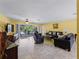 Bright living room with leather furniture, a large TV, and sliding doors leading to the pool area at 424 Baycrest Dr, Venice, FL 34285