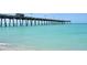 Long pier extending over calm, clear ocean water at 857 Tartan Dr, Venice, FL 34293