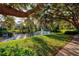 Serene waterfront path with lush greenery and majestic oak trees at 4114 Central Sarasota Pkwy # 1136, Sarasota, FL 34238