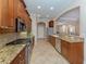 Modern kitchen with granite countertops and stainless steel appliances at 145 Montelluna Dr, North Venice, FL 34275