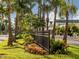 Attractive neighborhood entrance with lush landscaping and a black metal fence at 145 Montelluna Dr, North Venice, FL 34275