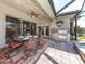 Outdoor kitchen and dining area with pool access at 145 Montelluna Dr, North Venice, FL 34275