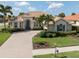 Luxury house with tile roof, landscaping, and a large driveway at 145 Montelluna Dr, North Venice, FL 34275