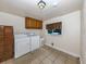 Laundry room with washer, dryer, and cabinets at 605 Barnes Pkwy, Nokomis, FL 34275