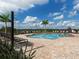 Community pool with plenty of lounge chairs and a shower at 2585 Hobblebrush Dr, North Port, FL 34289