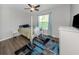Cozy bedroom with a full-size bed and wood floors at 2585 Hobblebrush Dr, North Port, FL 34289