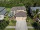 Two-story house with a three-car garage and landscaping at 2585 Hobblebrush Dr, North Port, FL 34289