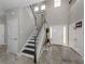 Two-story entryway with staircase, tile floors, and white doors at 2585 Hobblebrush Dr, North Port, FL 34289