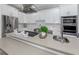 Modern kitchen with white cabinets, stainless steel appliances and breakfast bar at 2585 Hobblebrush Dr, North Port, FL 34289