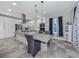 Modern kitchen with white cabinets, stainless steel appliances, and breakfast bar at 2585 Hobblebrush Dr, North Port, FL 34289