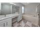 Elegant bathroom with double vanity, soaking tub, and shower at 2585 Hobblebrush Dr, North Port, FL 34289