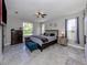 Large main bedroom with ceiling fan and backyard view at 2585 Hobblebrush Dr, North Port, FL 34289