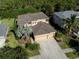 Two-story house with a three-car garage and landscaping at 2585 Hobblebrush Dr, North Port, FL 34289