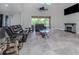 Spacious living room with high ceilings, leather furniture, and a fireplace at 2585 Hobblebrush Dr, North Port, FL 34289