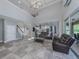 Spacious living room with high ceilings, sofas, and tile floors at 2585 Hobblebrush Dr, North Port, FL 34289