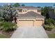 Two-story house with a three-car garage and landscaping at 2585 Hobblebrush Dr, North Port, FL 34289