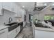 Modern kitchen with white cabinets, stainless steel appliances and a large island at 2585 Hobblebrush Dr, North Port, FL 34289