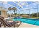 Relaxing pool area with screened enclosure and lounge chairs at 1211 Cheshire, Port Charlotte, FL 33953