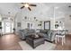 Open living space with gray sectional and wood flooring at 1211 Cheshire, Port Charlotte, FL 33953