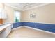 Spacious office with built-in desk and blue and beige walls at 653 Crossfield Cir # 8, Venice, FL 34293