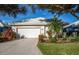 Single story home with white garage door and landscaped yard at 653 Crossfield Cir # 8, Venice, FL 34293