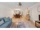 Bright living room with hardwood floors, featuring a comfortable sofa and dining area at 886 Bird Bay Way # 206, Venice, FL 34285