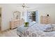 Bedroom with light flooring, dresser, and sliding door to patio at 886 Bird Bay Way # 206, Venice, FL 34285