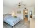 Main bedroom with a view of the bathroom and a queen-size bed at 886 Bird Bay Way # 206, Venice, FL 34285