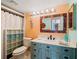 Charming bathroom with a unique vanity, shower, and decorative mirror at 886 Bird Bay Way # 206, Venice, FL 34285