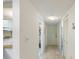 Bright hallway with light wood floors and access to rooms at 886 Bird Bay Way # 206, Venice, FL 34285